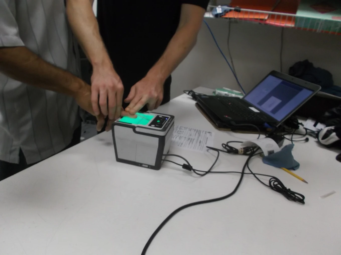 Live scan fingerprinting device in use at Del Mar Live Scans
